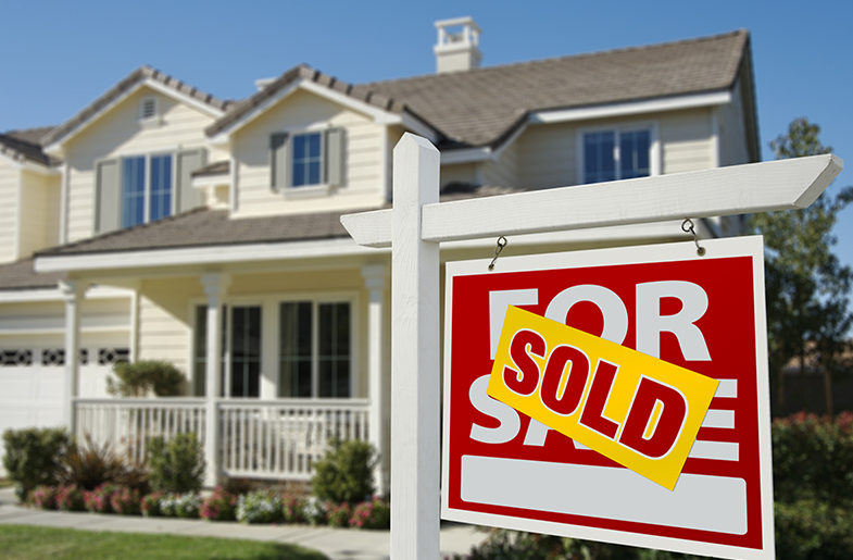 Home with a for sale sign in front