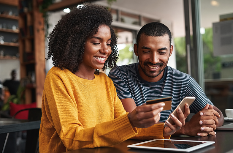 Couple using a credit card to make an online purchase
