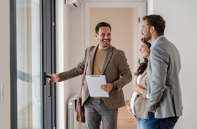 Man opening door while talking to other people