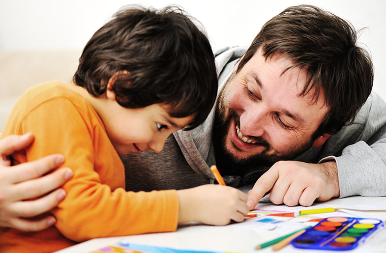Man coloring with son