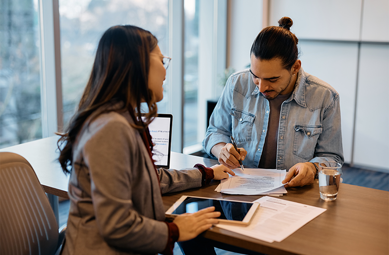 person filling out paperwork with lender
