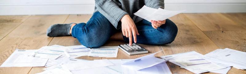 Woman doing paper work with calculator