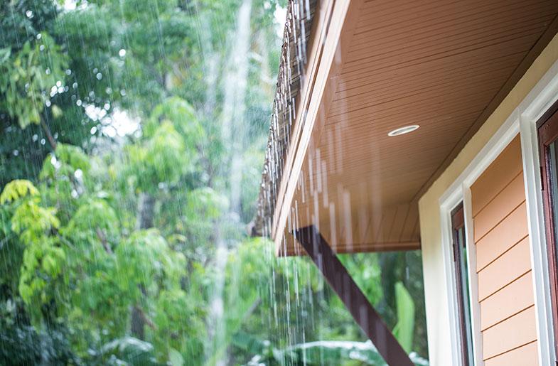 Rain falling from the roof of a single-family house