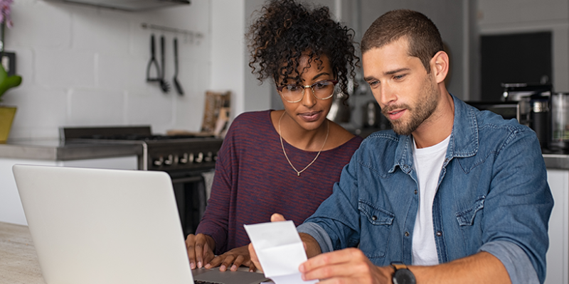Couple sitting in front of laptop
