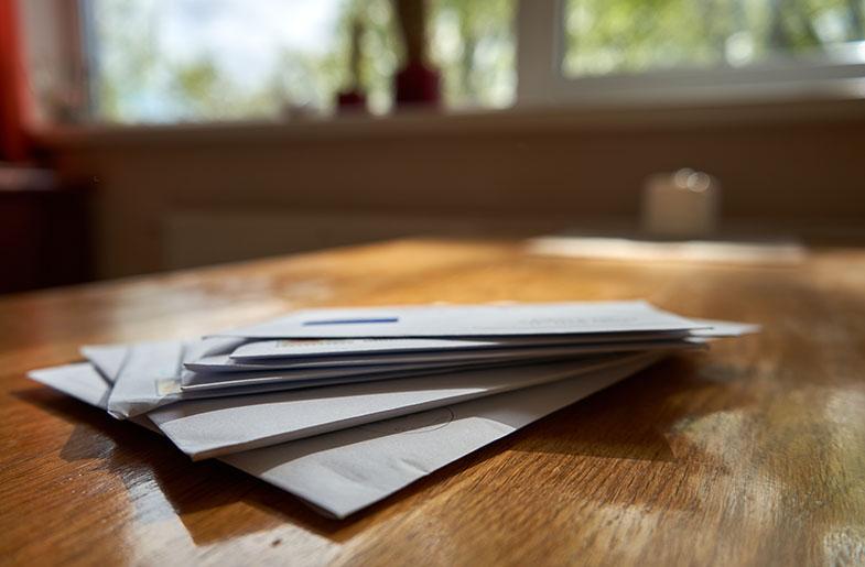 table top with a stack of mail on it