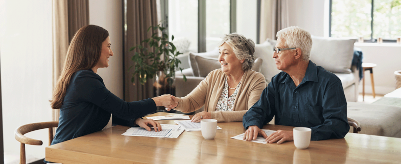 Older couple meeting with real estate professional