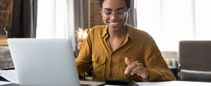 Woman on laptop and calculator 