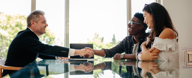 Two men and woman shaking hands